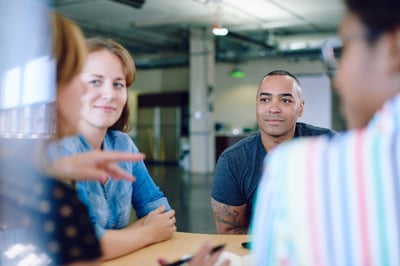 Unposed group of creative business people in an open concept office brainstorming their next project.